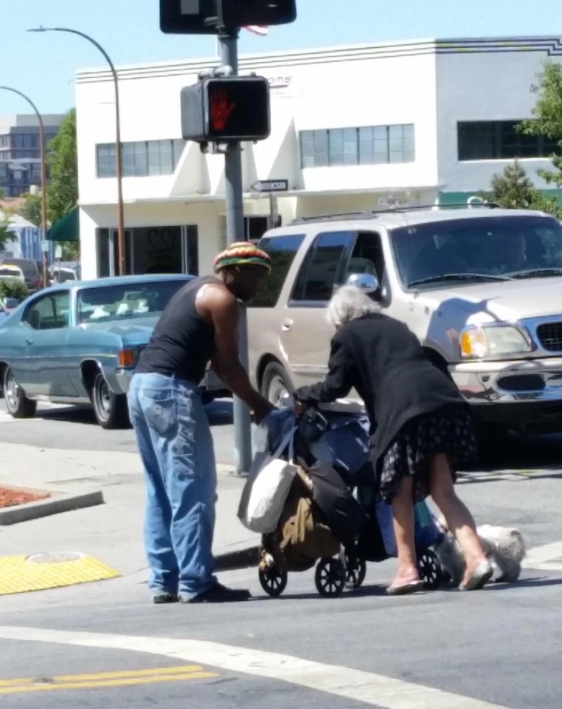 A man helping an old disabled lady
